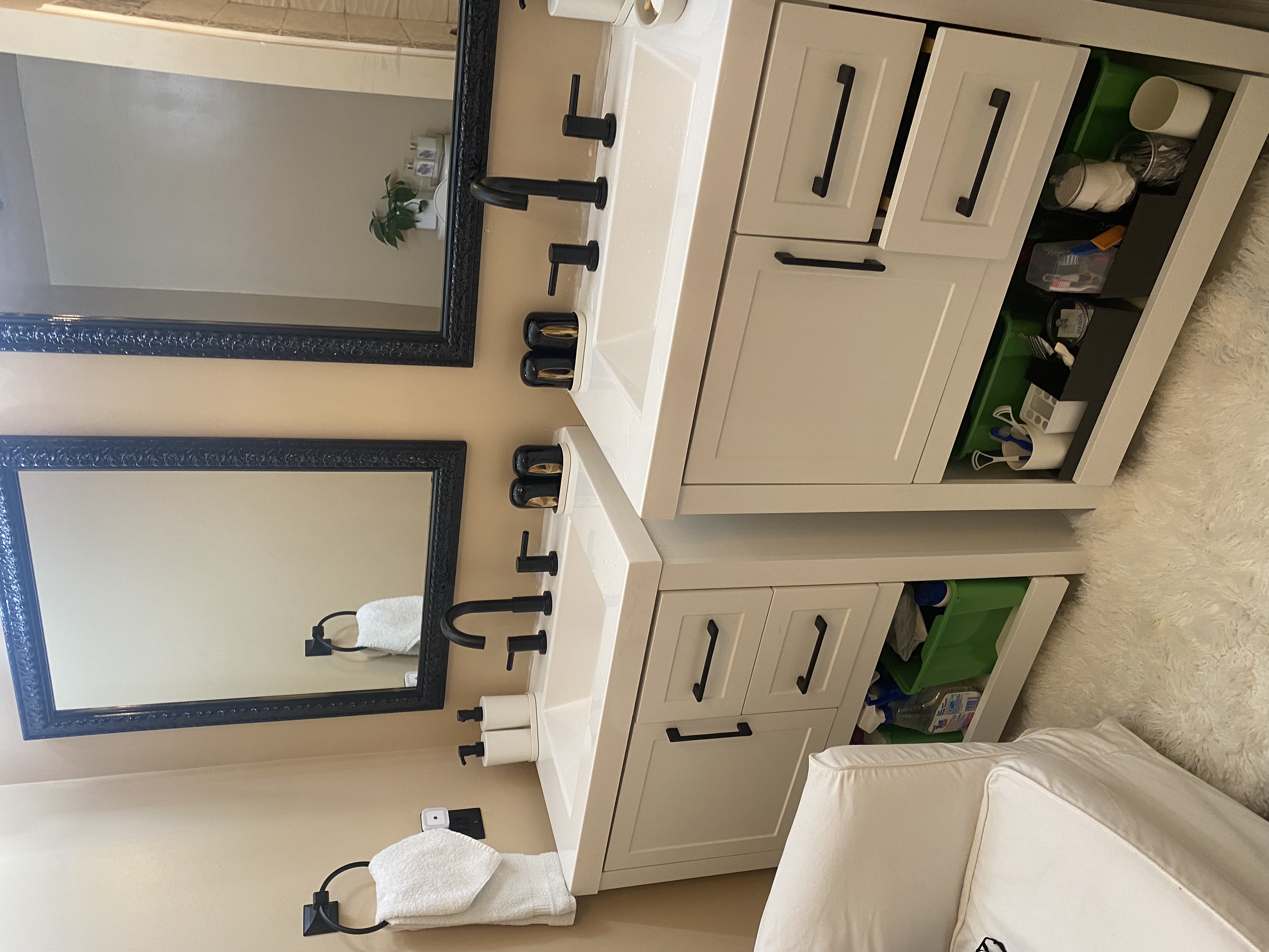 Bathroom vanity pair with matte black faucets and mirrors