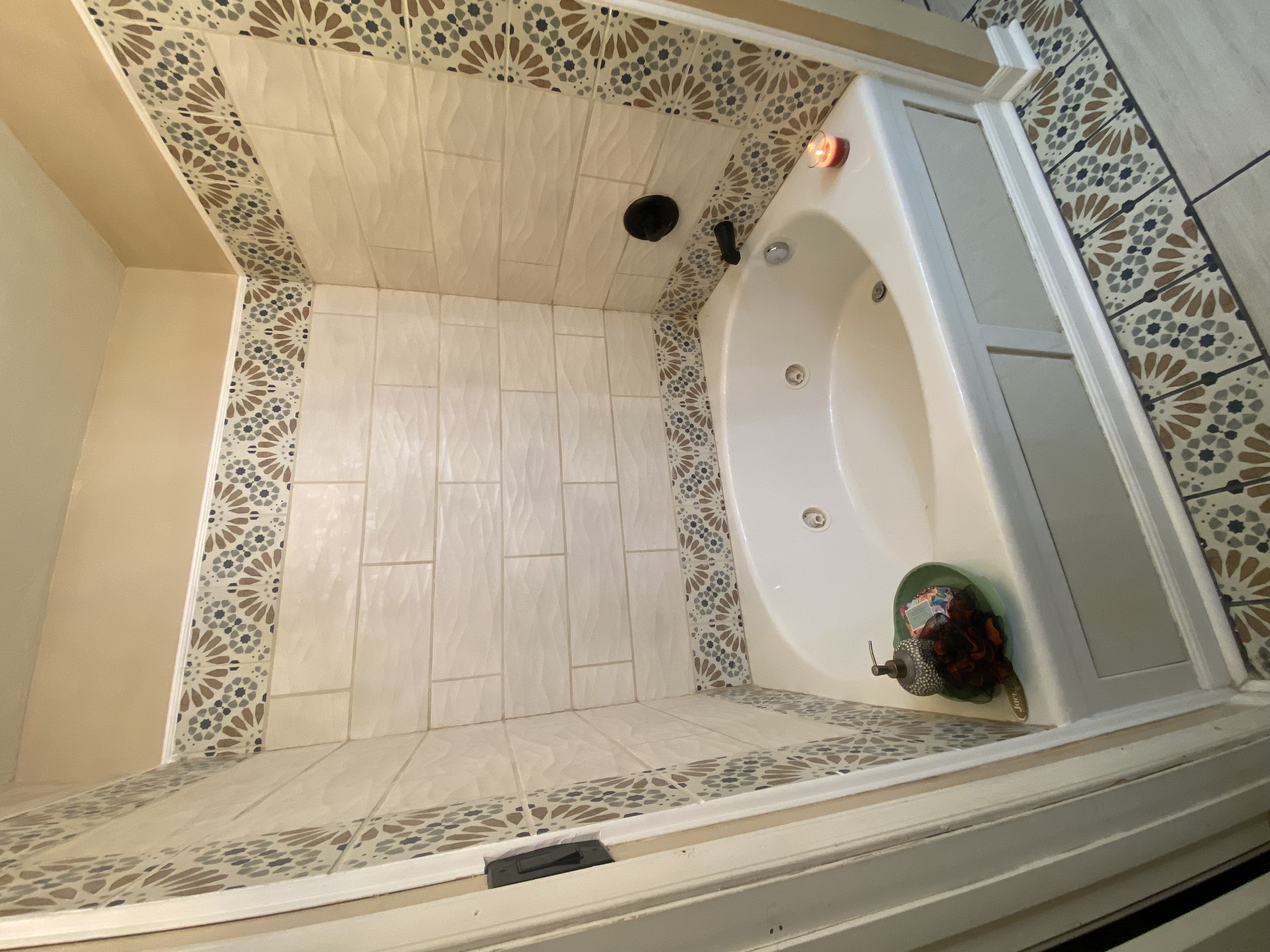 Accessible bathroom — walk‑in tub with mosaic tile surround