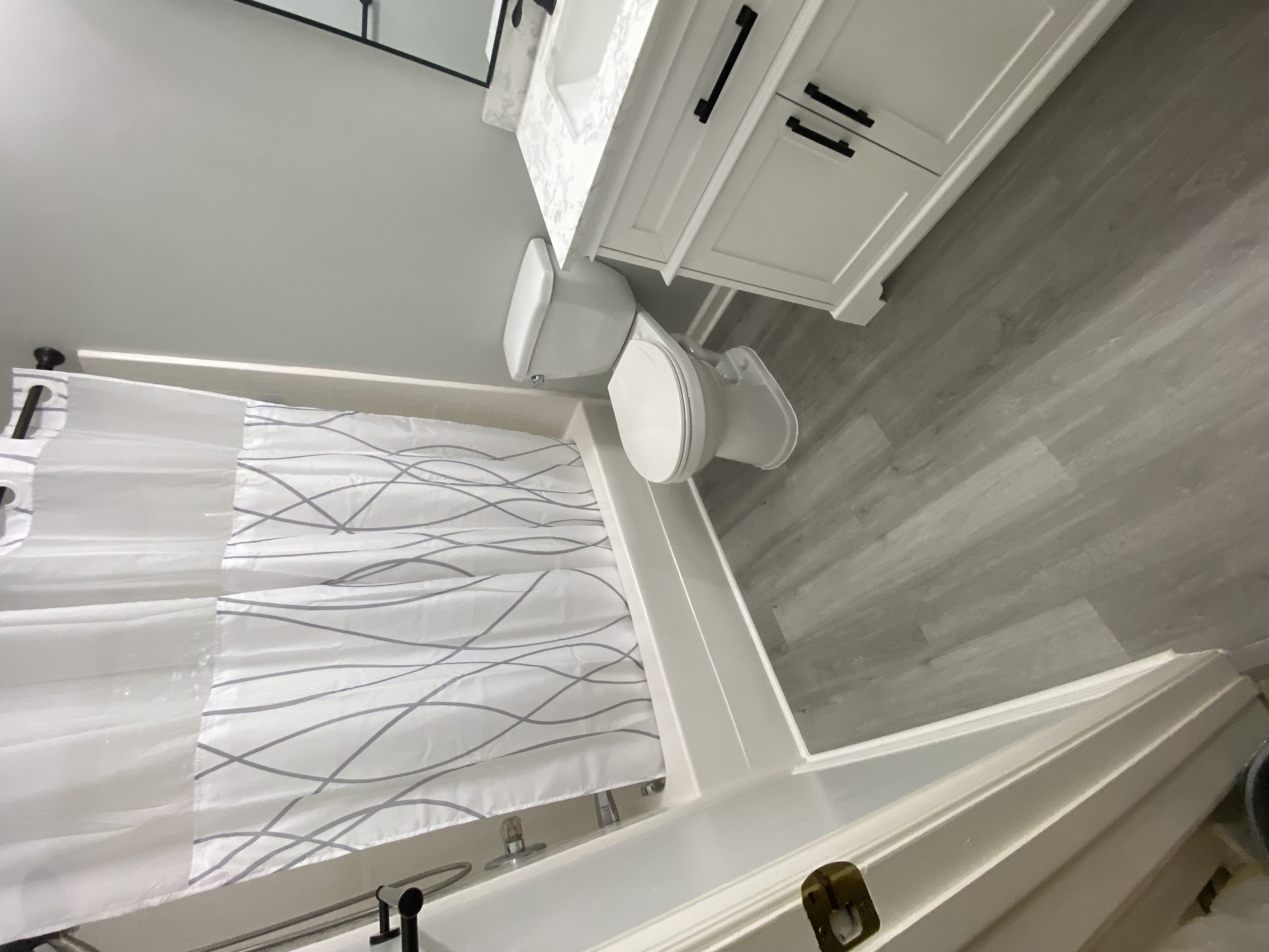 Custom shower — tiled walls, niche, pebble floor, and linear drain