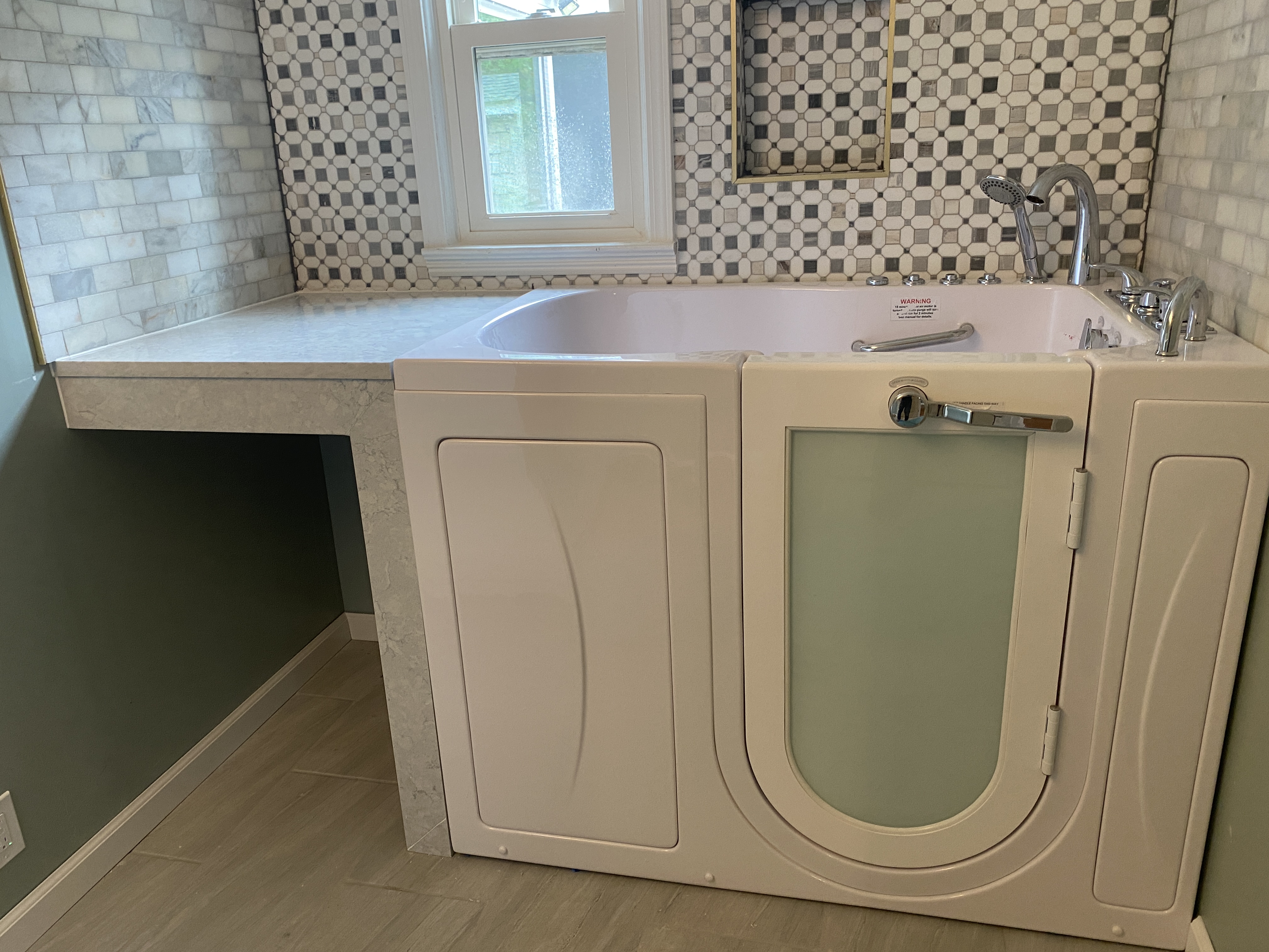 Another angle — jetted tub with patterned tile and feature wall